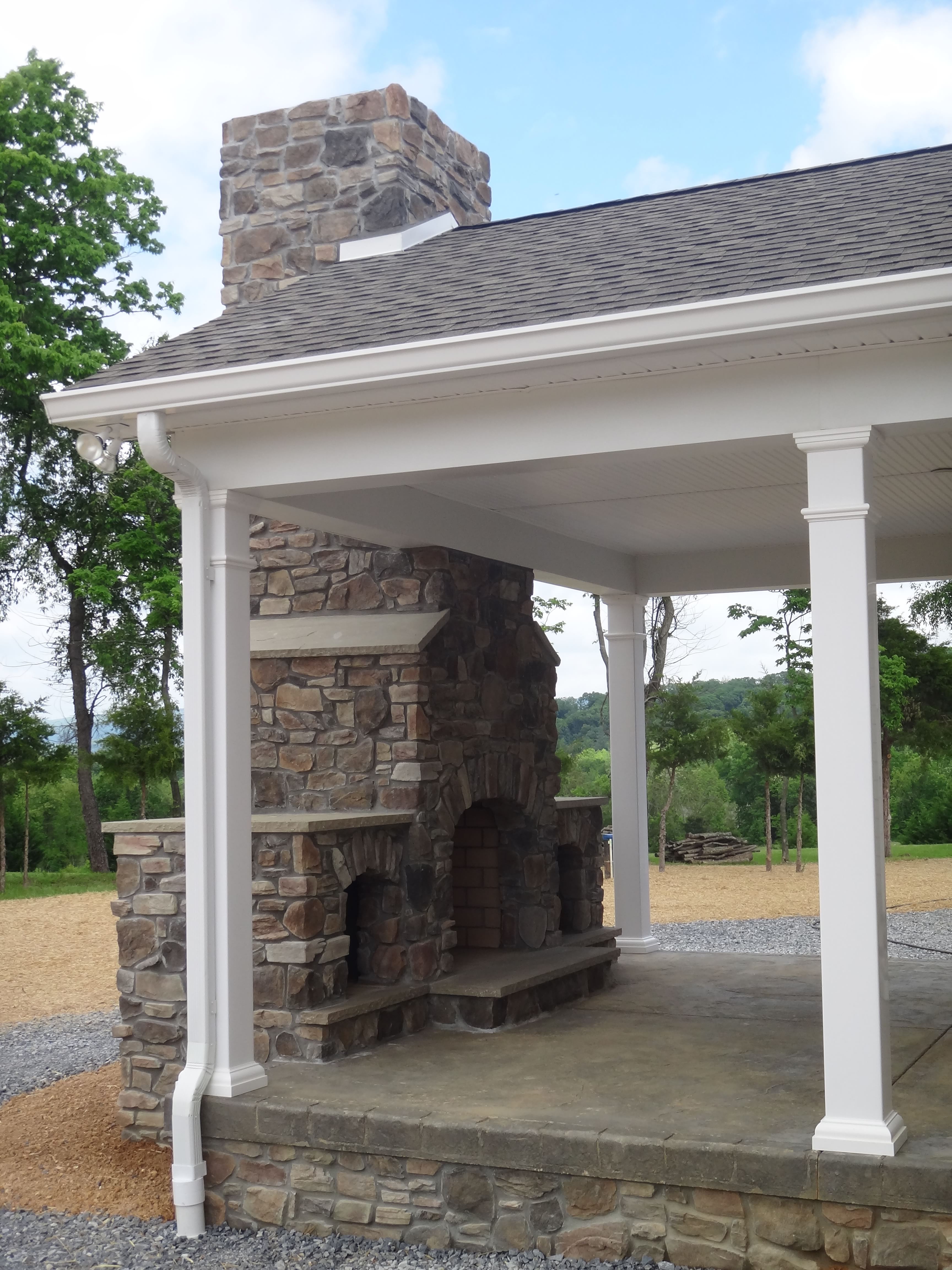 stone fireplace in outdoor living area