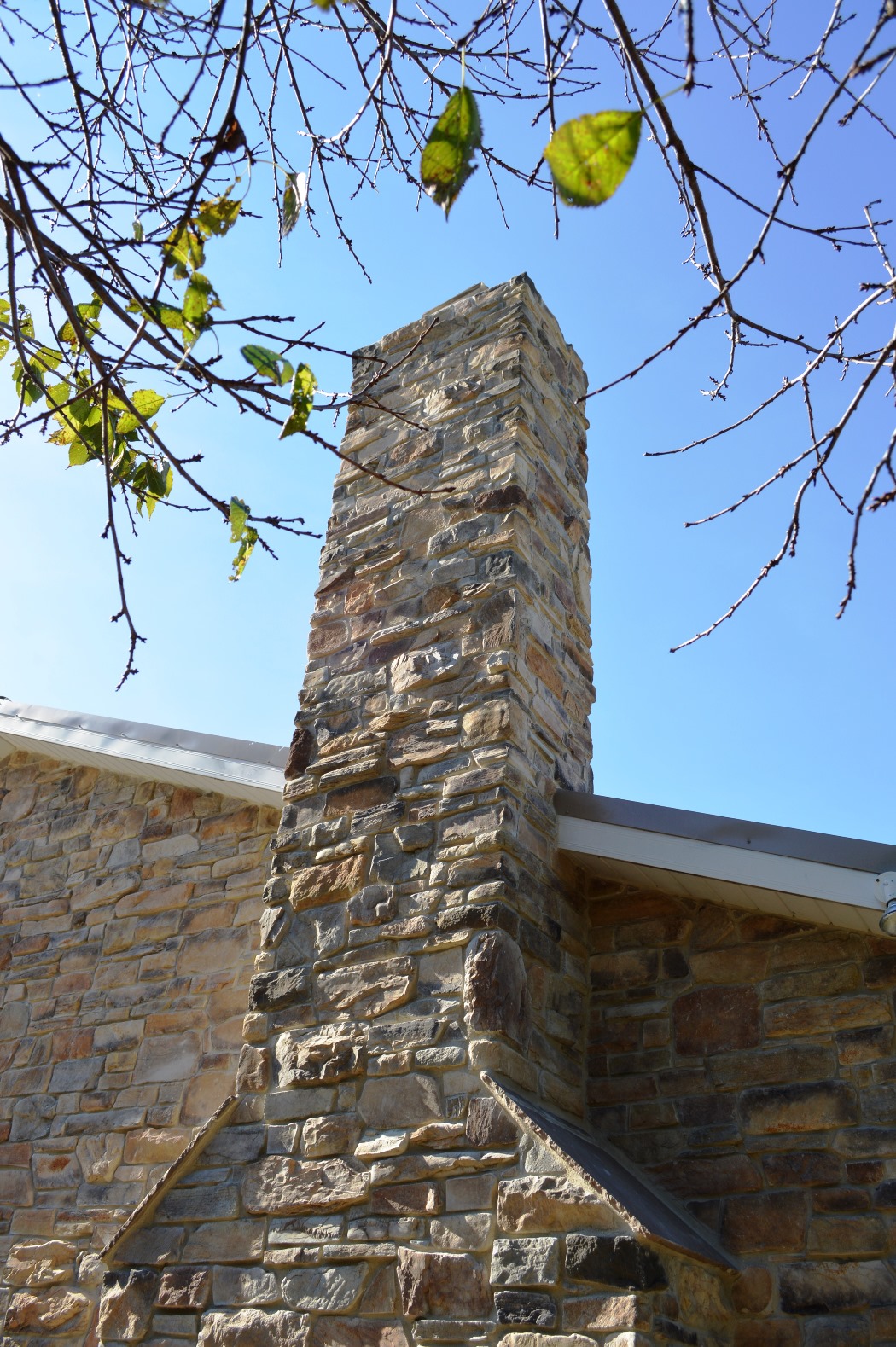Stone chimney on colonial renovation in Clear Spring, MD by Mt. Tabor Builders, Inc.